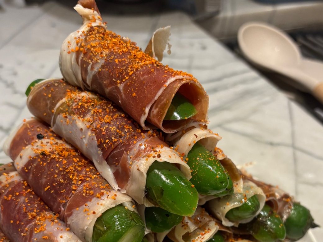 Prosciutto-wrapped jalapeño rolls dusted with chilli, from a Chicago private chef